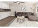 Open-concept living room features hardwood floors, modern decor, and lots of natural light at 6572 E Dakota Ave, Denver, CO 80224