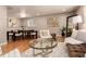 Open-concept living area featuring contemporary furniture, a modern rug, and hardwood floors at 6572 E Dakota Ave, Denver, CO 80224
