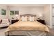 Comfortable main bedroom with a large window, plush bed, and ambient lighting at 6572 E Dakota Ave, Denver, CO 80224