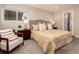 Serene main bedroom with a reading chair, a large bed, and soft, neutral tones at 6572 E Dakota Ave, Denver, CO 80224