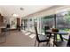 Bright sunroom with floor-to-ceiling windows, carpet, patio access, and flexible seating arrangements at 6572 E Dakota Ave, Denver, CO 80224