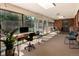 Sunroom with carpet, floor-to-ceiling windows, a desk, chairs, and access to a backyard at 6572 E Dakota Ave, Denver, CO 80224