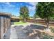 Landscaped backyard featuring a wooden fence and ample parking space at 1596 S Stuart St, Denver, CO 80219