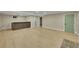 Open basement area with a built-in bar, wood-look flooring, and neutral walls at 1596 S Stuart St, Denver, CO 80219