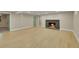 Finished basement with a cozy fireplace, laminate wood flooring and a door leading to another room at 1596 S Stuart St, Denver, CO 80219