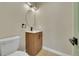 Powder bathroom featuring an elegant vanity, contemporary fixtures, and wood look flooring at 1596 S Stuart St, Denver, CO 80219
