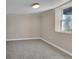 Neutral colored bedroom with grey carpet and natural lighting from a small window at 1596 S Stuart St, Denver, CO 80219