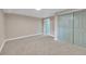 Carpeted bedroom featuring a neutral color scheme, closet, and blue painted door at 1596 S Stuart St, Denver, CO 80219