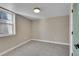 Bedroom with a window letting in natural light, neutral walls, and soft carpet at 1596 S Stuart St, Denver, CO 80219