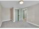 Neutral bedroom with gray carpet, walk in closet with painted doors, and natural lighting at 1596 S Stuart St, Denver, CO 80219