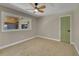 Neutral bedroom featuring a ceiling fan, carpet and a view to the backyard from the window at 1596 S Stuart St, Denver, CO 80219
