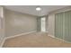 Bedroom with neutral carpet, paint, large closet, natural lighting and painted door at 1596 S Stuart St, Denver, CO 80219