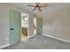 Bedroom featuring an ensuite bathroom, neutral walls and carpet with ample natural light at 1596 S Stuart St, Denver, CO 80219