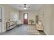 Inviting entryway with a ceiling fan, sleek console table, and a modern accent chair and area rug at 1596 S Stuart St, Denver, CO 80219