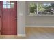 Inviting entryway features a classic maroon front door and seamless access to the naturally lit main living area at 1596 S Stuart St, Denver, CO 80219