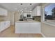 Kitchen featuring white cabinets, butcher block countertops, modern fixtures, and tiled backsplash at 1596 S Stuart St, Denver, CO 80219