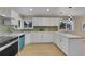 Bright kitchen showcasing white cabinets, wooden countertops, with modern appliances and ample natural light at 1596 S Stuart St, Denver, CO 80219