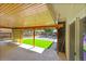 Covered patio overlooking a backyard, featuring wood ceiling and artificial turf at 1596 S Stuart St, Denver, CO 80219