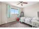 Bright bedroom with carpet, ceiling fan, and large window at 4569 S Lowell Blvd # C, Denver, CO 80236