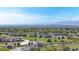Scenic aerial view of a neighborhood with a golf course, pond, and lush greenery, offering picturesque scenery at 2314 Flagstaff Dr, Longmont, CO 80504