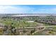 Expansive aerial view of a community with a golf course, lake, and beautiful landscape under a blue sky at 2314 Flagstaff Dr, Longmont, CO 80504