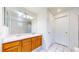 Bathroom with dual vanity, white tile flooring, and a large mirror at 2314 Flagstaff Dr, Longmont, CO 80504