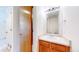 Half bathroom with a wooden vanity and a white sink at 2314 Flagstaff Dr, Longmont, CO 80504