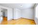 Bright bedroom featuring hardwood flooring, a sliding closet, and a window at 2314 Flagstaff Dr, Longmont, CO 80504