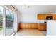 Eat-in kitchen and dining area with wooden cabinetry and sliding glass doors at 2314 Flagstaff Dr, Longmont, CO 80504