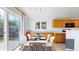 Eat-in kitchen and dining area with wooden cabinetry and sliding glass doors at 2314 Flagstaff Dr, Longmont, CO 80504