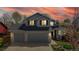 Charming two-story home featuring a gray exterior, brick accents, an attached two car garage, and a vibrant sunset at 2314 Flagstaff Dr, Longmont, CO 80504