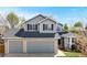 Charming two-story home with a two-car garage, gray siding, and a well-maintained front yard at 2314 Flagstaff Dr, Longmont, CO 80504