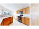 Well-equipped kitchen with oak cabinets, black appliances, and tile floors at 2314 Flagstaff Dr, Longmont, CO 80504