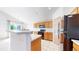 Bright kitchen with oak cabinets, black appliances, and countertop seating at 2314 Flagstaff Dr, Longmont, CO 80504