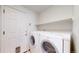Laundry room featuring a full size washer and dryer, a white door, and an overhead shelf at 2314 Flagstaff Dr, Longmont, CO 80504