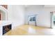 Well-lit living room with fireplace, hardwood floors, large window, and sliding glass door to the backyard at 2314 Flagstaff Dr, Longmont, CO 80504