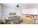 Bright living room featuring a ceiling fan, wooden floors, and a comfortable sofa at 2314 Flagstaff Dr, Longmont, CO 80504