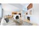 Open-concept living space featuring hardwood floors, fireplace, and seamless transition to kitchen with dining area at 2314 Flagstaff Dr, Longmont, CO 80504