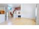 Bright living room with fireplace, soaring ceilings, and an open staircase with red accents at 2314 Flagstaff Dr, Longmont, CO 80504