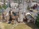 Aerial view of the property showcasing the multiple structures, stone work, yard and outdoor living spaces at 1 Gooseberry Ln, Cherry Hills Village, CO 80113