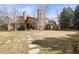 Backyard featuring stone pathway leading to a house with tall trees and manicured lawn at 1 Gooseberry Ln, Cherry Hills Village, CO 80113