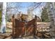 Backyard with wooden gate and stone pillars, showcasing privacy and charm at 1 Gooseberry Ln, Cherry Hills Village, CO 80113