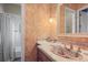 Full bathroom with a patterned sink, decorative walls, and a shower-tub combo at 1 Gooseberry Ln, Cherry Hills Village, CO 80113