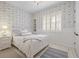 Quaint bedroom featuring lovely wallpaper, crisp white trim, and a plush bed at 1 Gooseberry Ln, Cherry Hills Village, CO 80113