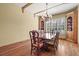 Charming dining room with hardwood floors, decorative chandelier, and natural light from the window at 1 Gooseberry Ln, Cherry Hills Village, CO 80113