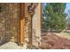 Close up of exterior detail including stonework, downspout, and landscaping at 1 Gooseberry Ln, Cherry Hills Village, CO 80113