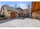 Charming home showcasing stone and stucco exterior, with arched entry and garage at 1 Gooseberry Ln, Cherry Hills Village, CO 80113