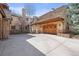 Exterior view of the home with a multi-car garage and spacious driveway at 1 Gooseberry Ln, Cherry Hills Village, CO 80113