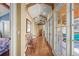 Sun-drenched hallway with hardwood floors, bench, and expansive windows letting in natural light at 1 Gooseberry Ln, Cherry Hills Village, CO 80113