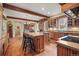 Spacious kitchen with wooden cabinets, a large island, hardwood floors and stainless steel appliances at 1 Gooseberry Ln, Cherry Hills Village, CO 80113